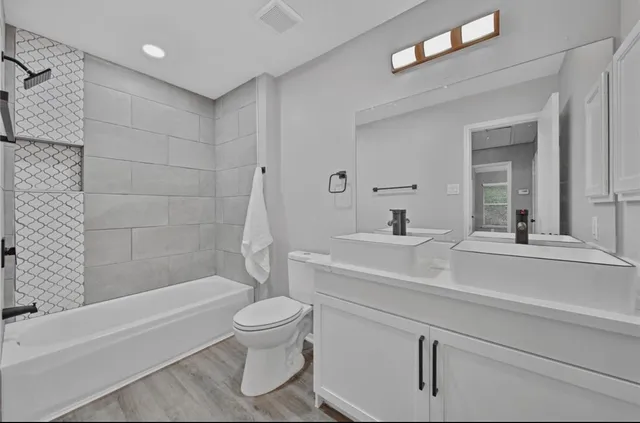 a bathroom with a sink a toilet and a bathtub