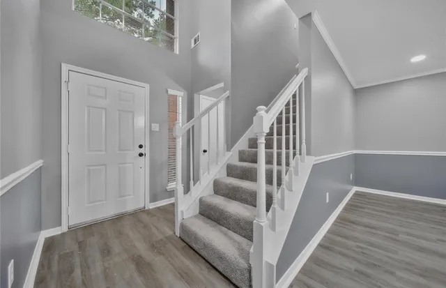 a view of entryway and hall with wooden floor