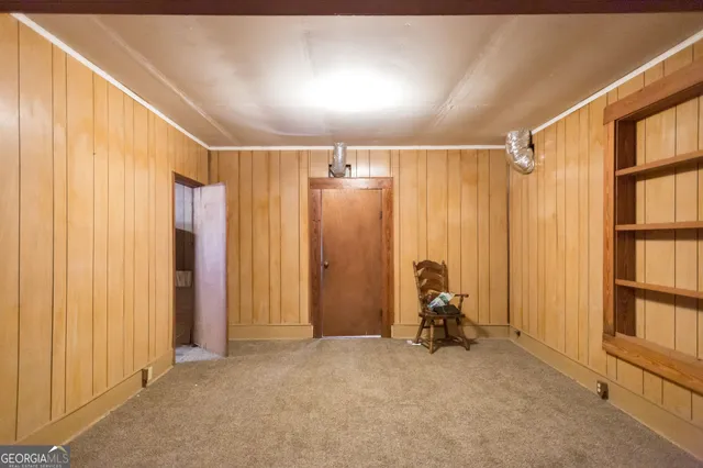 a view of a hallway with wooden shelves