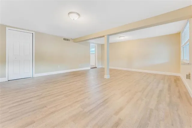 wooden floor in an empty room with a window