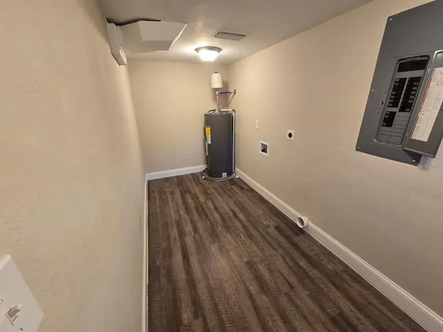 a view of a room with wooden floor