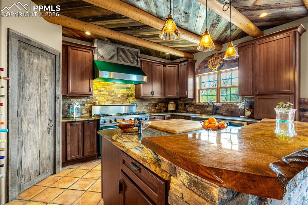 11960 Old Pueblo Road Fountain, CO 80817 - Photo 21 of 50 a kitchen with stainless steel appliances granite countertop a sink a stove and a wooden cabinets