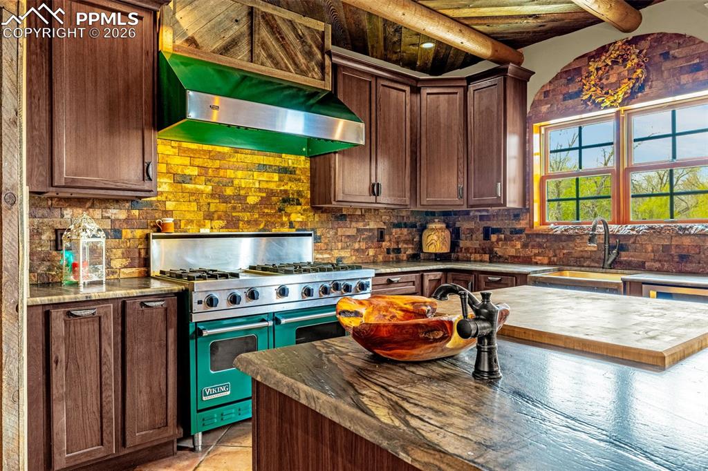 11960 Old Pueblo Road Fountain, CO 80817 - Photo 22 of 50 a kitchen with a stove a sink and a wooden cabinets