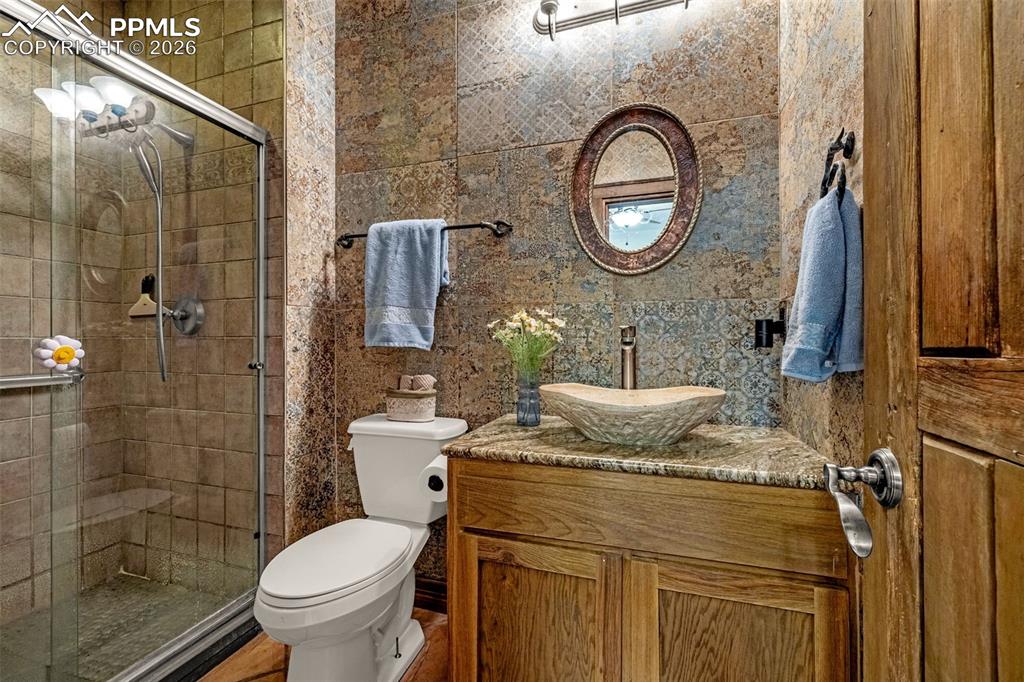 11960 Old Pueblo Road Fountain, CO 80817 - Photo 32 of 50 a bathroom with a granite countertop toilet sink and shower