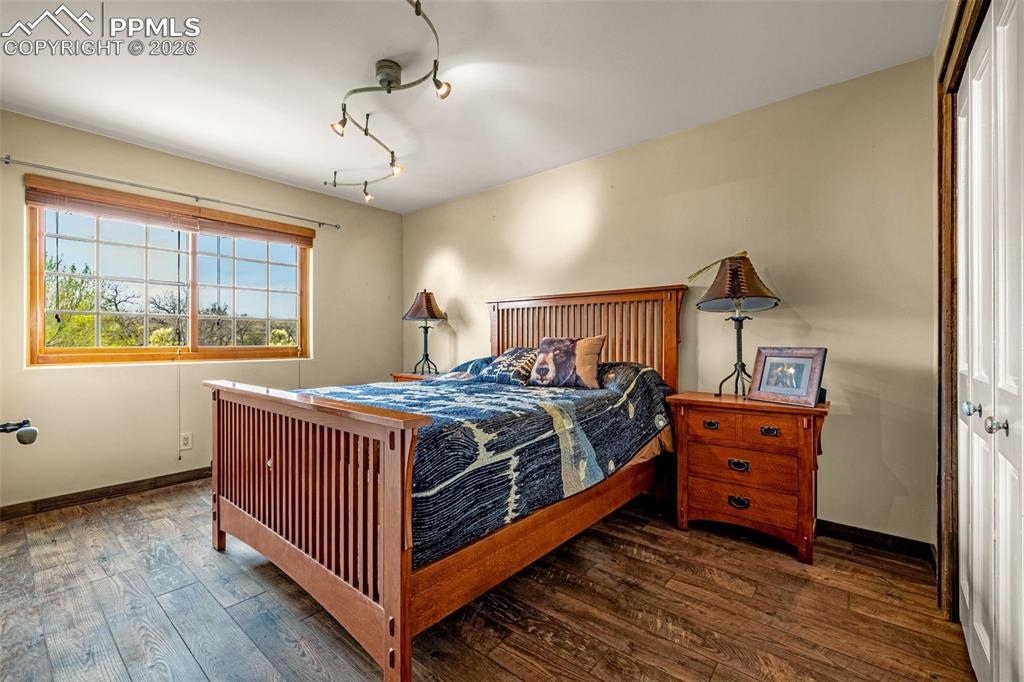 11960 Old Pueblo Road Fountain, CO 80817 - Photo 33 of 50 a bedroom with a bed and wooden floor