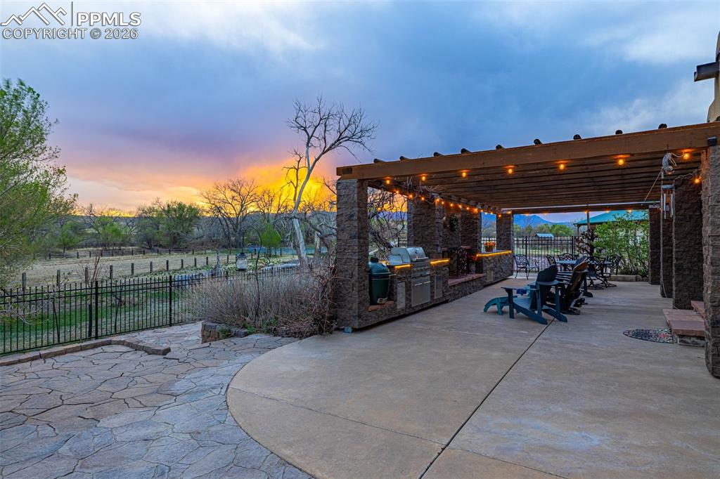11960 Old Pueblo Road Fountain, CO 80817 - Photo 10 of 50 a view of a patio with table and chairs under an umbrella with a small yard