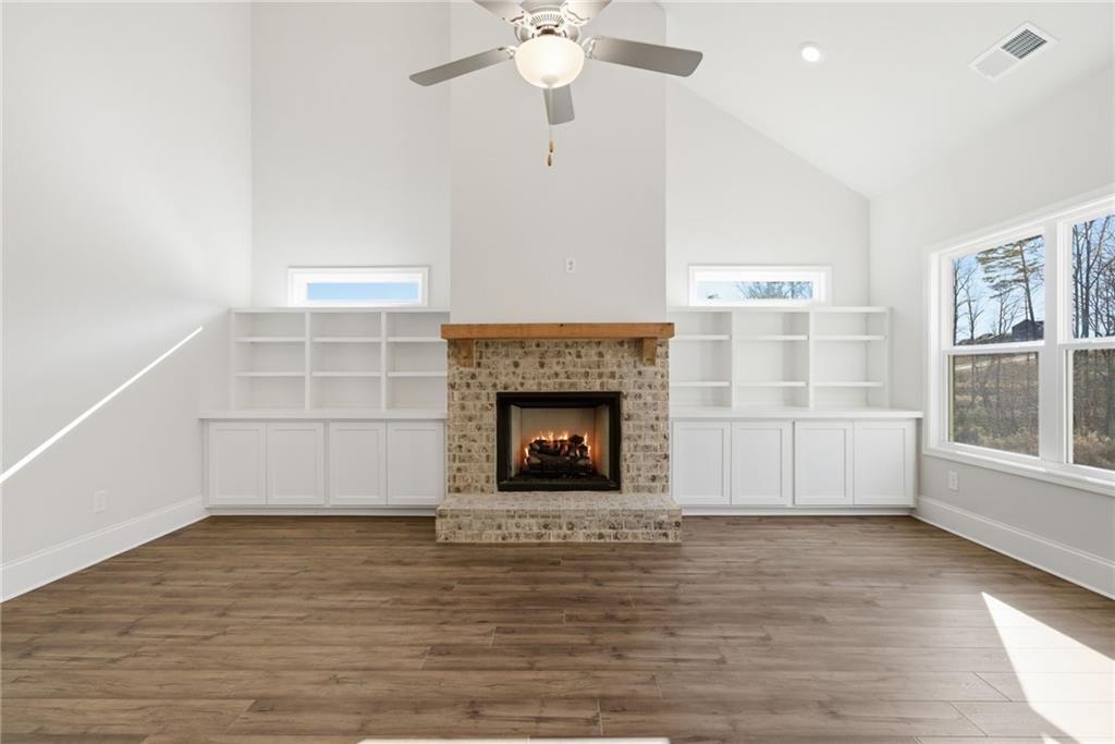 2540 Parkside Way Gainesville, GA 30507 - Photo 12 of 53 a view of a livingroom with a fireplace a ceiling fan and windows