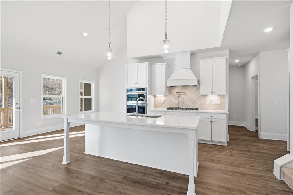 2540 Parkside Way Gainesville, GA 30507 - Photo 17 of 53 a kitchen with stainless steel appliances granite countertop a stove a sink dishwasher and a refrigerator with wooden floor