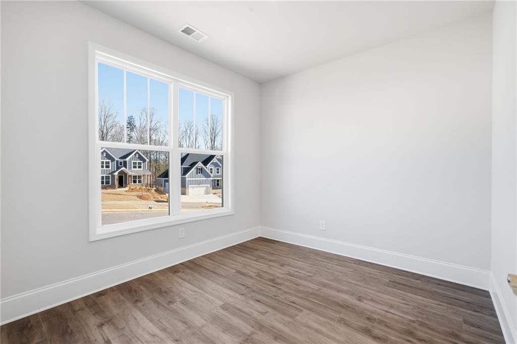 2540 Parkside Way Gainesville, GA 30507 - Photo 22 of 53 an empty room with wooden floor and window