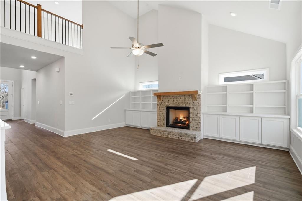 2540 Parkside Way Gainesville, GA 30507 - Photo 3 of 53 a view of a livingroom with a fireplace a ceiling fan and windows