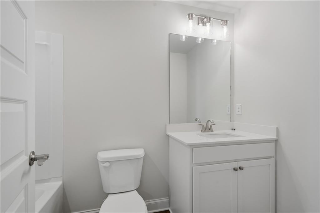 2540 Parkside Way Gainesville, GA 30507 - Photo 36 of 53 a bathroom with a sink a toilet and mirror