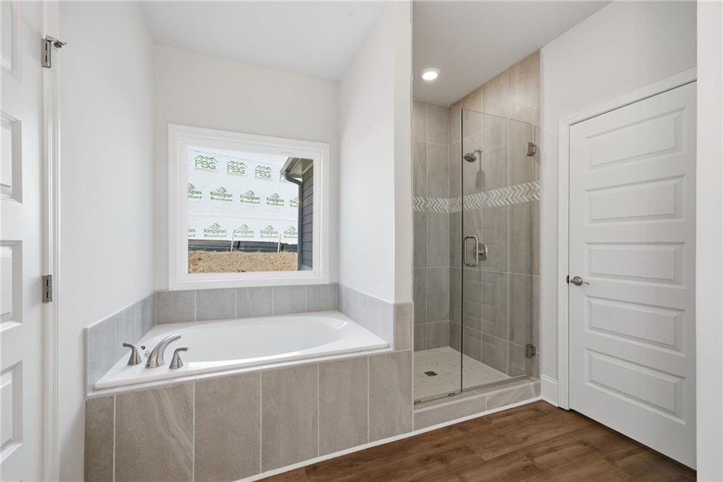 2540 Parkside Way Gainesville, GA 30507 - Photo 6 of 53 a bathroom with a tub shower vanity and a sink