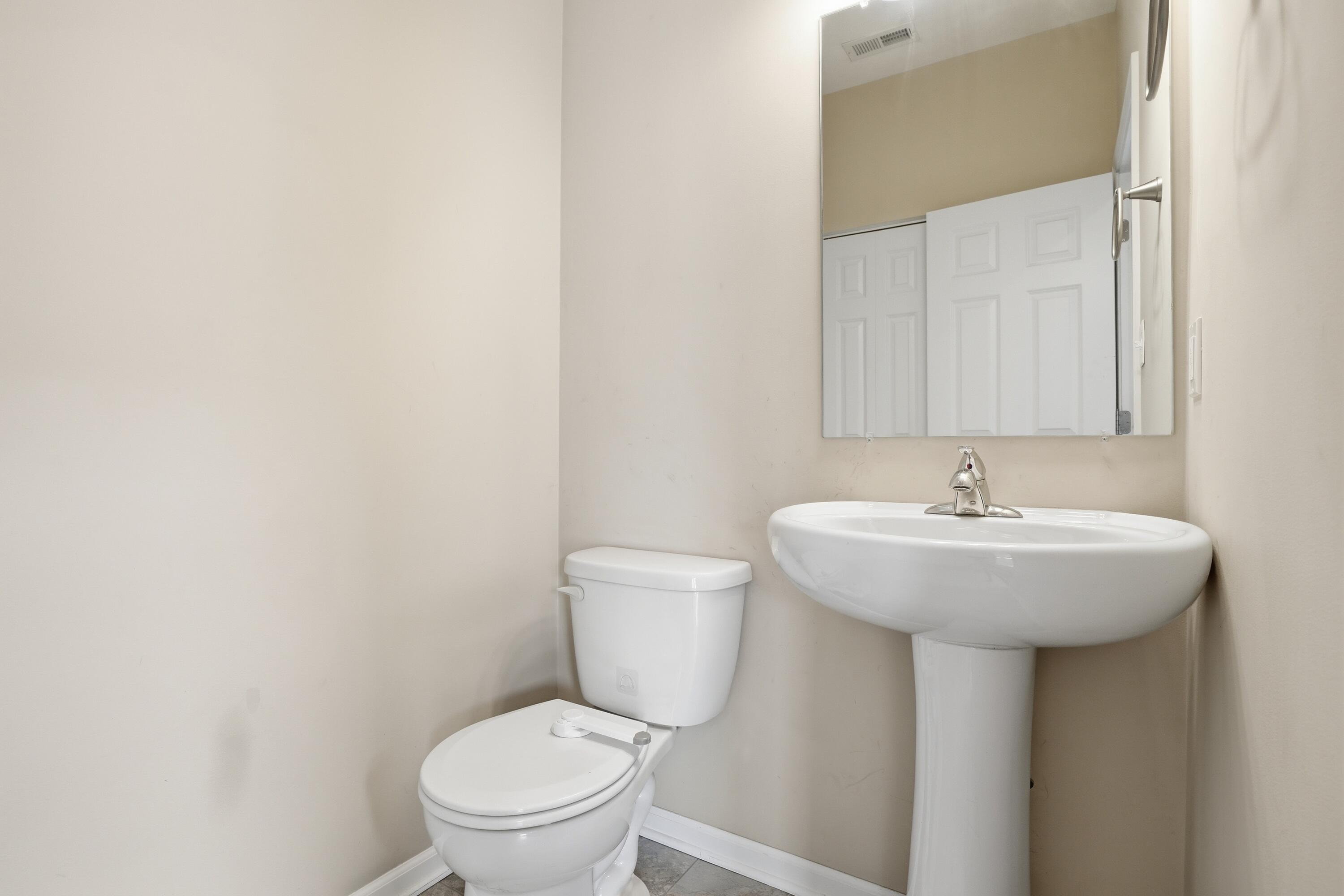 11351 Rhode Island Street Crown Point, IN 46307 - Photo 14 of 18 a bathroom with a toilet sink and mirror