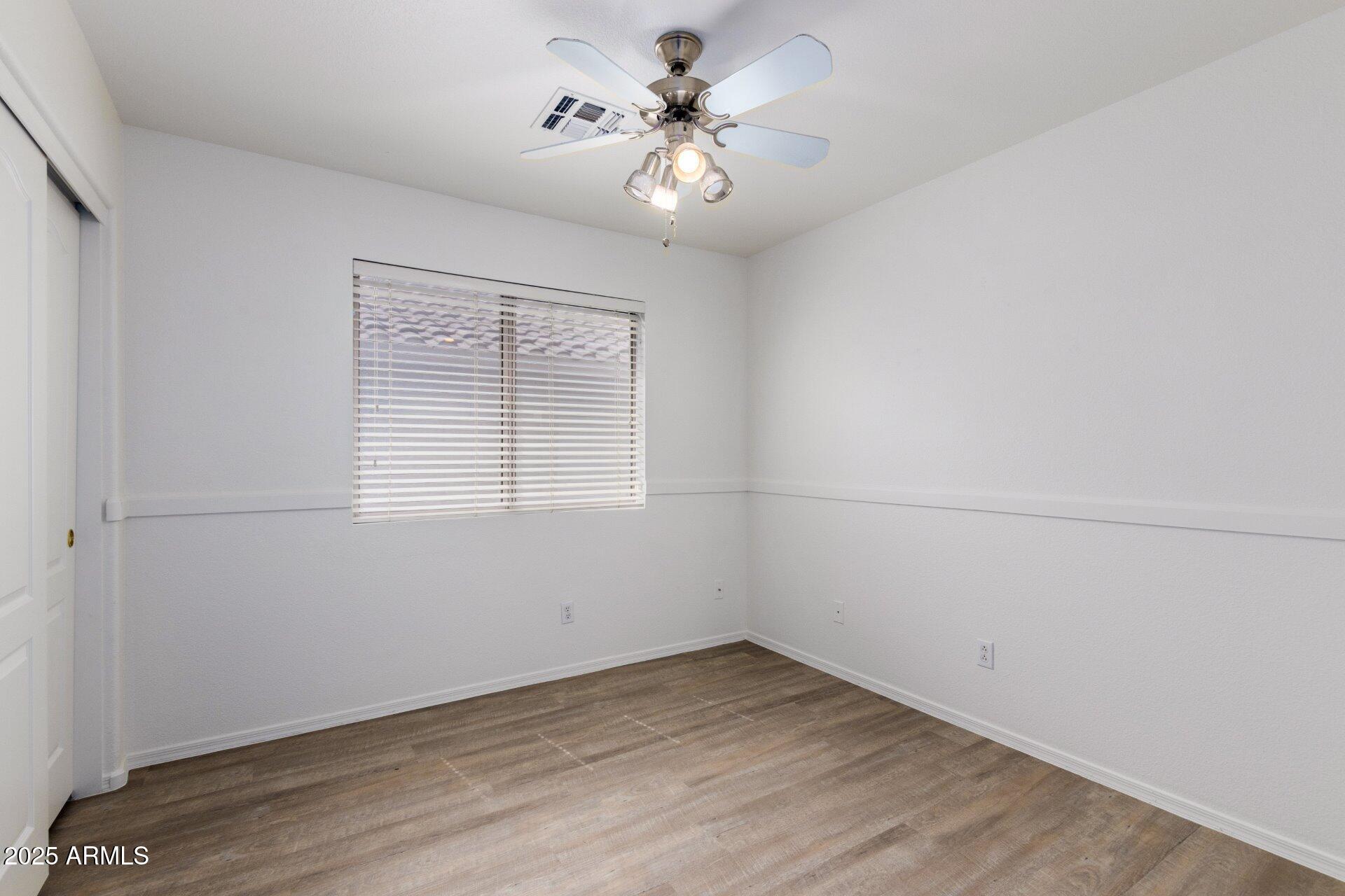 4443 East Rowel Road Phoenix, AZ 85050 - Photo 14 of 25 wooden floor in an empty room with a window