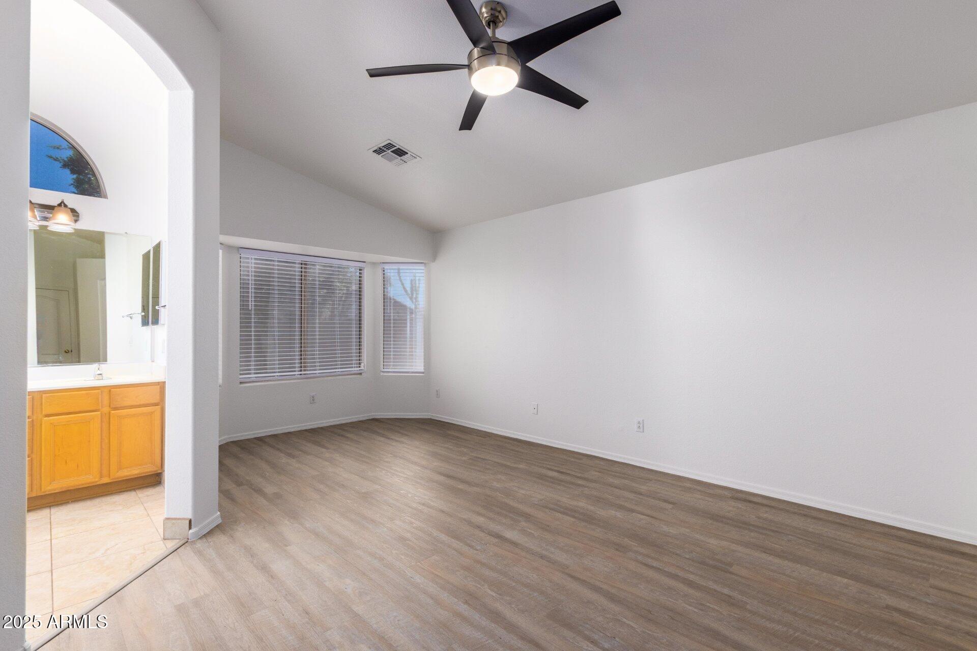 4443 East Rowel Road Phoenix, AZ 85050 - Photo 17 of 25 wooden floor in an empty room with a window