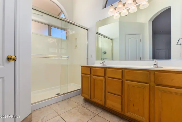 a bathroom with a shower sink and mirror