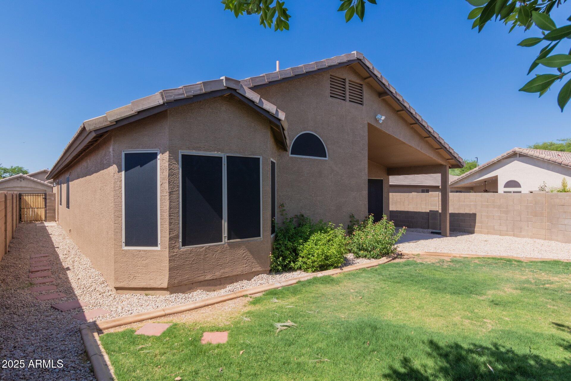 4443 East Rowel Road Phoenix, AZ 85050 - Photo 23 of 25 a front view of a house with a yard and garage