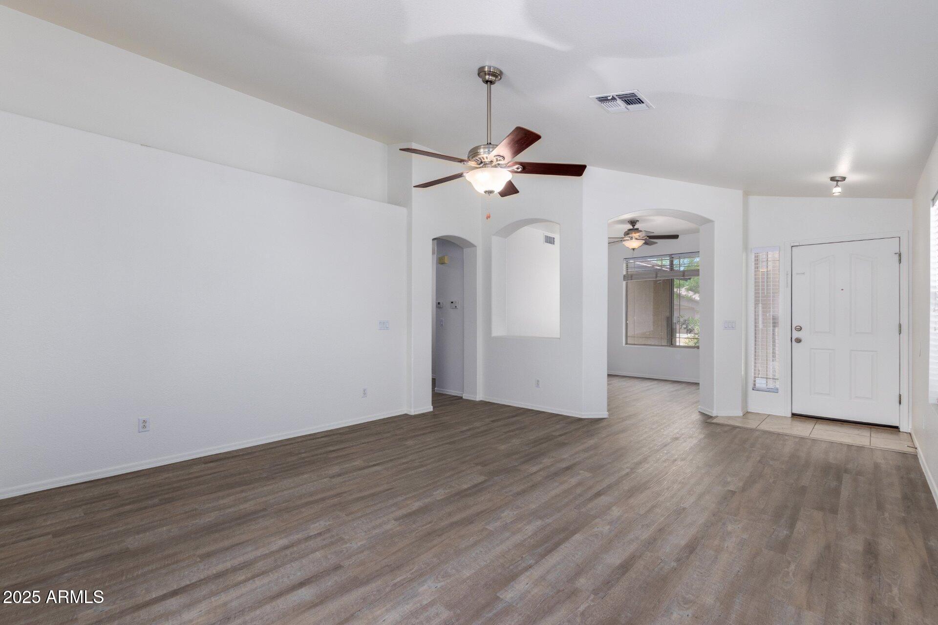 4443 East Rowel Road Phoenix, AZ 85050 - Photo 5 of 25 a view of a room with wooden floor and a ceiling fan