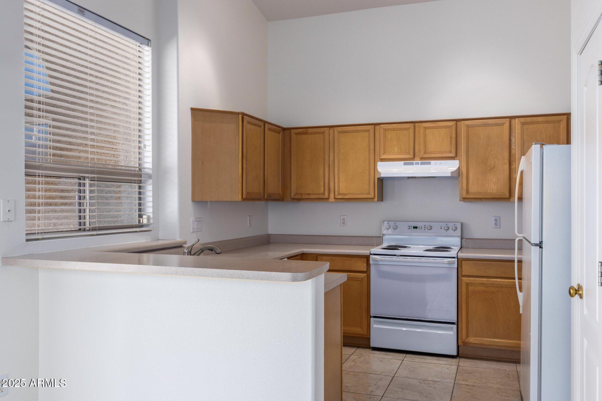 4443 East Rowel Road Phoenix, AZ 85050 - Photo 10 of 25 a kitchen with a sink a stove and a refrigerator
