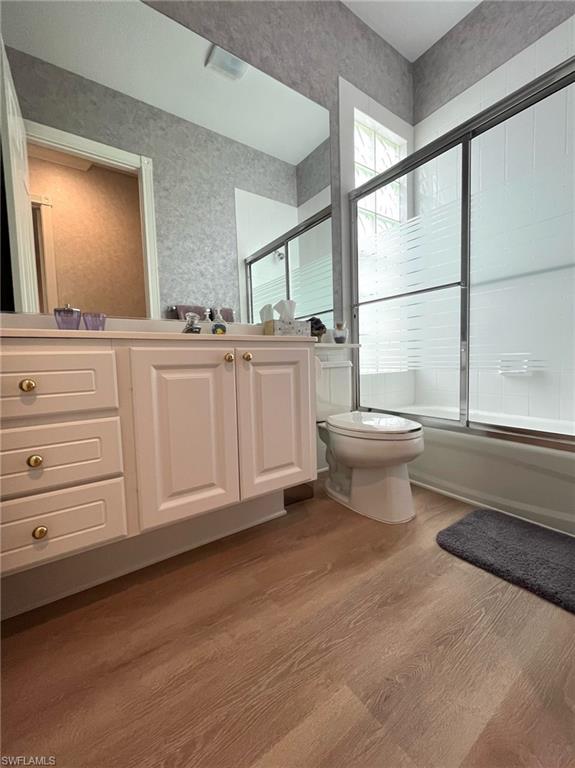 5477 Freeport Lane Naples, FL 34119 - Photo 18 of 36 a bathroom with a toilet a sink and a mirror