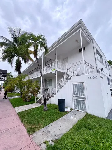 a view of a house with a yard and plants