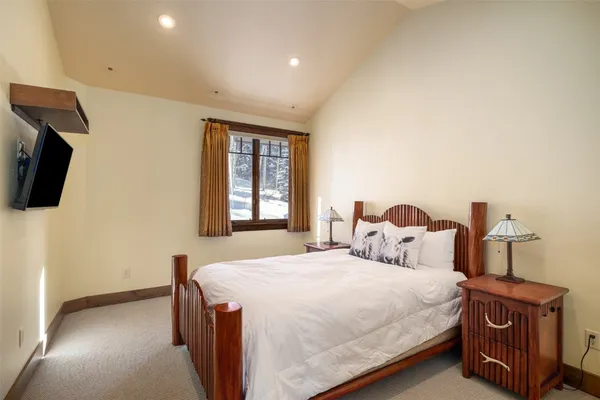 a bedroom with a bed and a tv