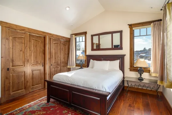 a large bed sitting in a bedroom next to a window