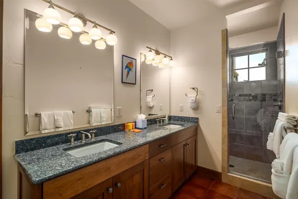 a bathroom with a granite countertop sink and a mirror