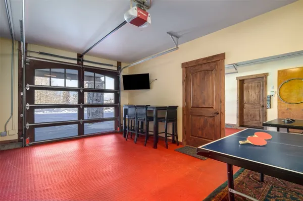 a room with furniture pool table and flat screen tv