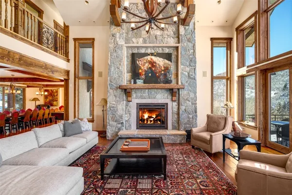 a living room with furniture a fireplace and a large window