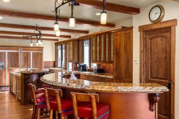 a dining table with chairs and window