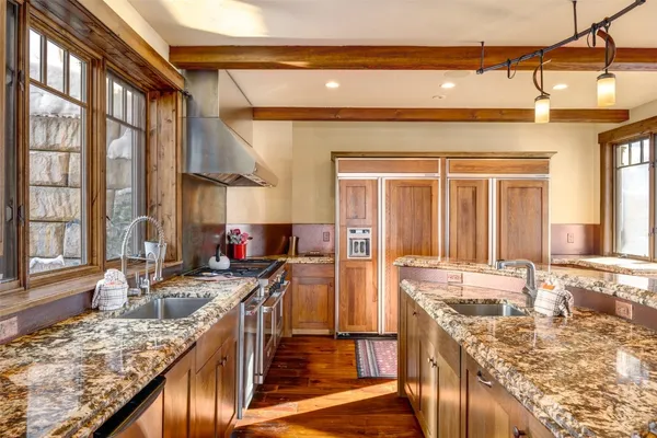 a kitchen with sink stove and cabinets