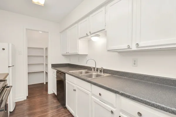a kitchen with cabinets appliances and a counter space