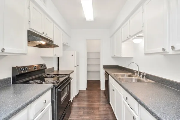 a kitchen with a sink stove and refrigerator