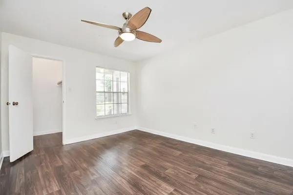 wooden floor in an empty room with a window
