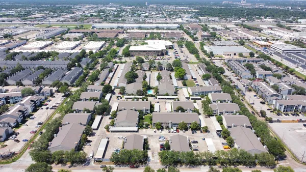an aerial view of residential houses with outdoor space