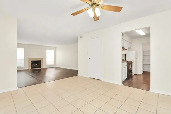a view of a livingroom with wooden floor and a ceiling fan