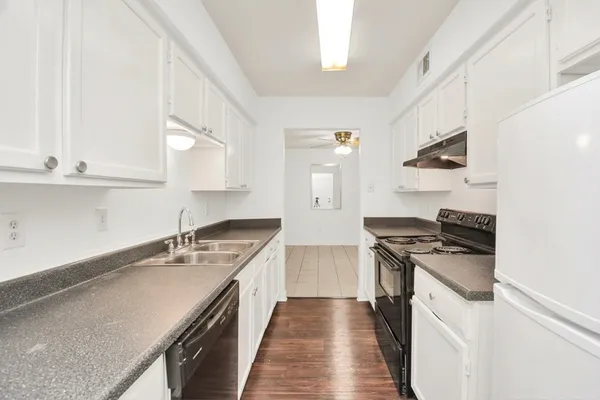 a kitchen with a sink stove and cabinets