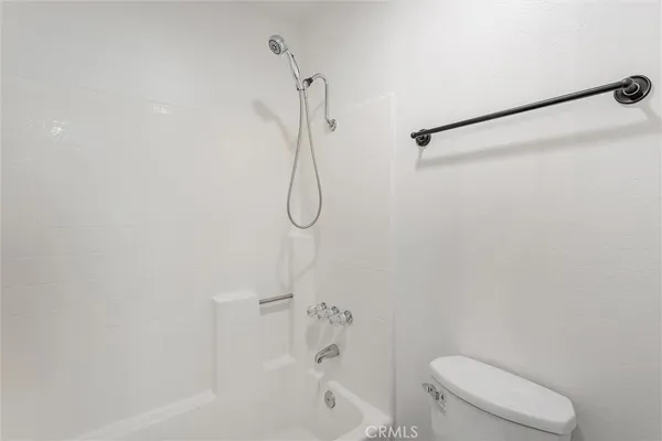 a bathroom with a shower a toilet and a shower