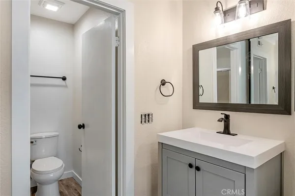 a bathroom with a sink a toilet and a mirror