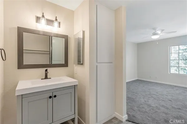 a bathroom with a sink vanity and a mirror