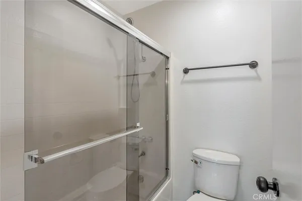 a bathroom with a shower and a toilet