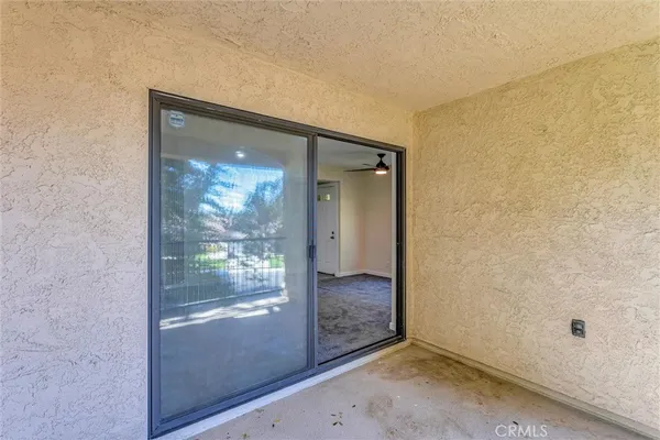 an empty room with sliding glass door