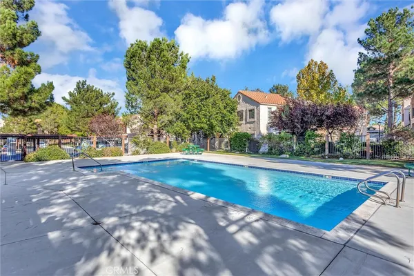 a view of a swimming pool with an outdoor space and seating area