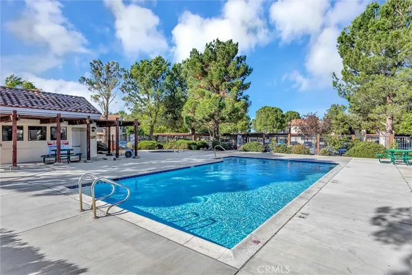 a view of a swimming pool with sitting area