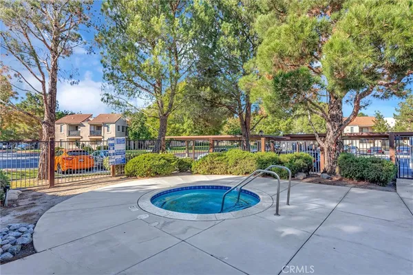 a view of a swimming pool with a patio and plants