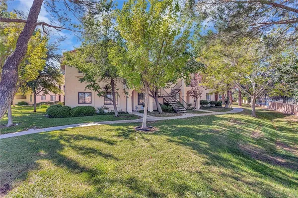 a view of a fountain in front of a house
