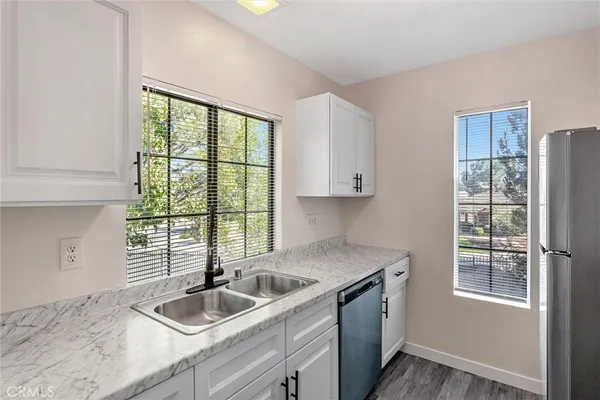 a kitchen with granite countertop a sink and a window