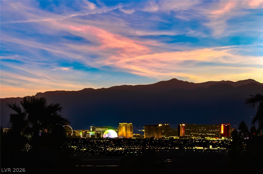 1104 Norellat Road Henderson, NV 89011 - Photo 49 of 52 A sweeping mountain backdrop frames the twinkling lights of the distant city skyline.