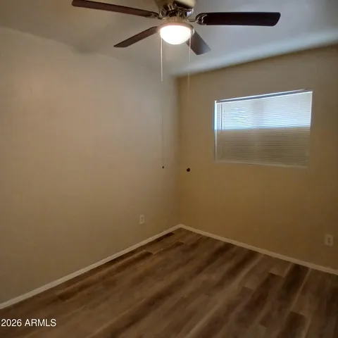 en empty room with a ceiling fan and a fan